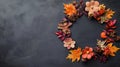 Autumn-themed wreath on a dark textured background. Royalty Free Stock Photo